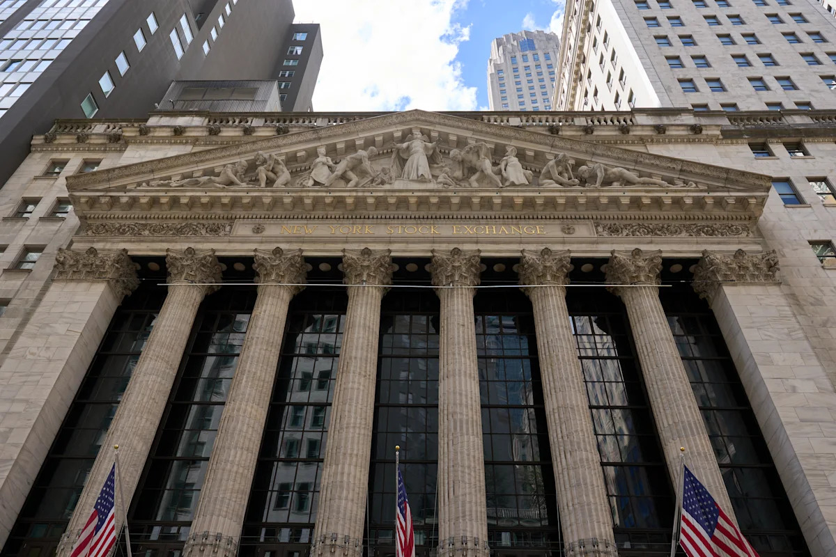 The New York Stock Exchange facade with American flags along the colonnade, marking Friday August 14 2026 when the S&P 500 slipped 0.2 percent from Thursday's record 7,798.99 to close at 7,785.76 after July retail sales fell 0.6 percent and preliminary August University of Michigan consumer sentiment dropped to 51, even as the index booked a third straight weekly gain