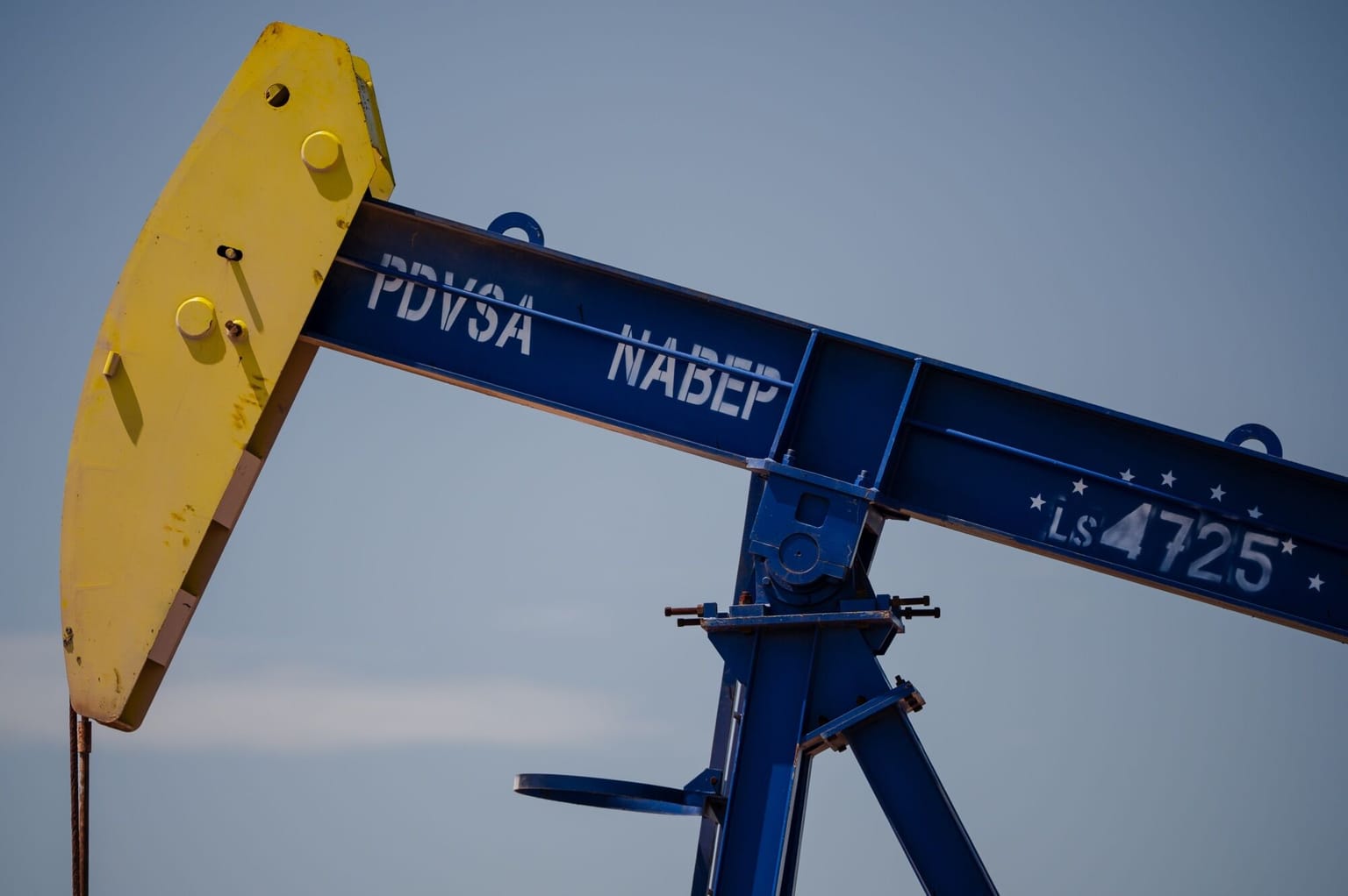 A blue and yellow PDVSA NABEP pumpjack marked LS 4725 against a clear sky in Cabimas, Venezuela, used as the ThriveInMarkets evening-review hero for Monday September 7 2026, when West Texas Intermediate held near 92.70 dollars and Brent settled 97.31 dollars after a 98.06 high as Iran vowed to strike Gulf energy infrastructure, US cash sat out Labor Day, and holiday E-mini S&P 500 futures last printed 7,708.75
