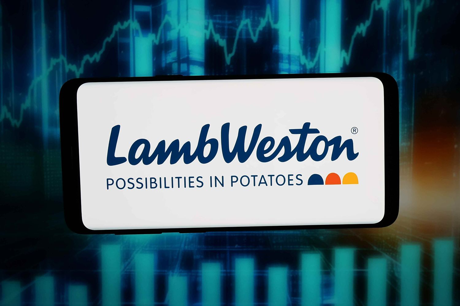 A phone showing the Lamb Weston logo over a dark trading-chart background, used as the ThriveInMarkets evening-review inline image for Tuesday October 6 2026, when Lamb Weston jumped about 9 percent after adjusted earnings of 0.75 dollars a share and the S&P 500 closed 7,818.93 at a record