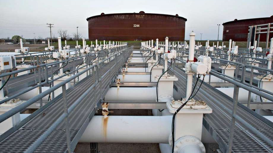 Crude storage tanks and a pipeline manifold at a Cushing-style tank farm, used as the ThriveInMarkets evening-review inline image for Wednesday October 7 2026, when EIA reported US crude stocks fell 3.2 million barrels and WTI last printed about 89 dollars