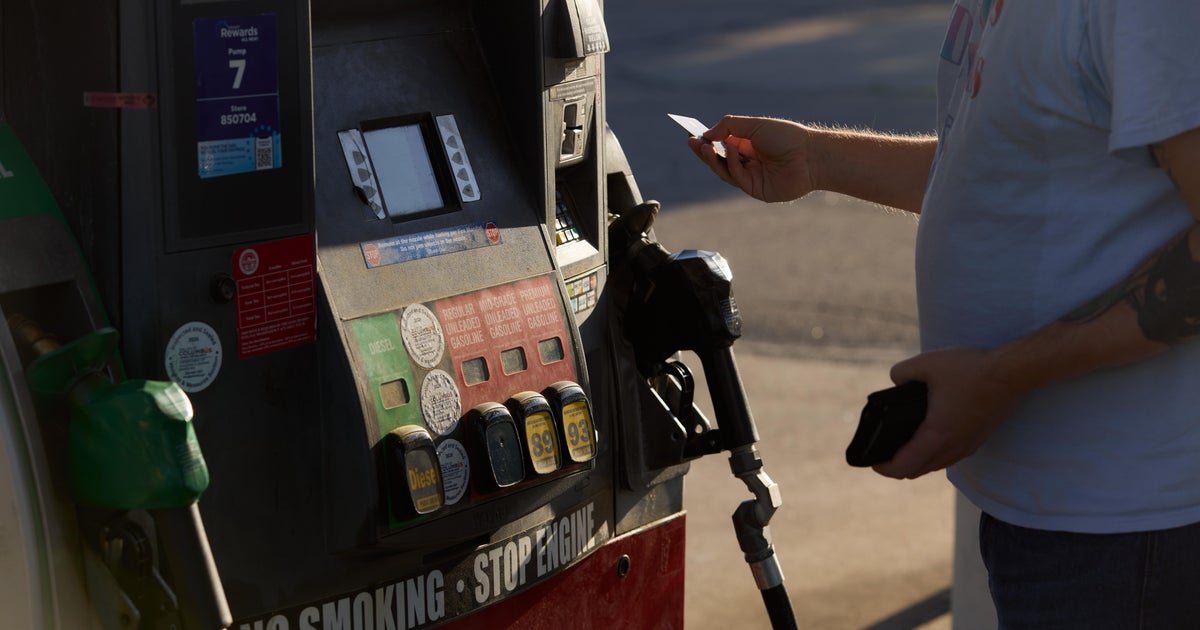Photograph of US grocery checkout and household goods illustrating the April 2026 CPI surge with gasoline up 28.4 percent year-over-year, food costs adding 0.5 percent on the month, and real average hourly wages slipping -0.5 percent in the month as the Iran war energy pulse bled into the sticky basket