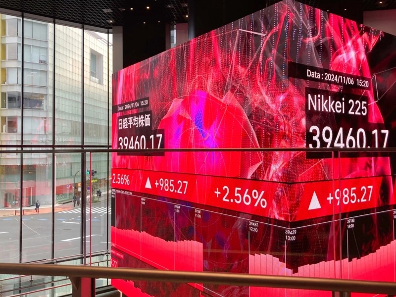 Photograph of the Tokyo Stock Exchange trading floor on Monday May 25 2026 as Japan's Nikkei 225 index breached 65,000 for the first time ever on an intraday basis surging 1,914.93 points or 3.02 percent to a record 65,254 close in holiday-thinned Asia trading as the US cash equity market remained shut for Memorial Day, with the rally led by SoftBank Group as the cleanest public-market AI proxy and semiconductor heavyweights including Kioxia Holdings that climbed 5.94 percent to 60,810 yen on the Philadelphia Semiconductor Index up 2 percent on Friday, JPMorgan projecting the benchmark to reach 70,000 by year-end on AI capex strength and a weaker yen, with the move catalyzed by mounting expectations of an imminent truce agreement between the United States and Iran following Trump's Sunday Truth Social declaration that a peace deal to reopen the Strait of Hormuz is largely negotiated and will be announced soon, which has sunk WTI crude 5.87 percent to 90.93 dollars per barrel and Brent 5.58 percent to 97.76 dollars in early Asia trade easing the war premium that has dominated commodity and rates structure since the February 28 2026 air war shut the strait