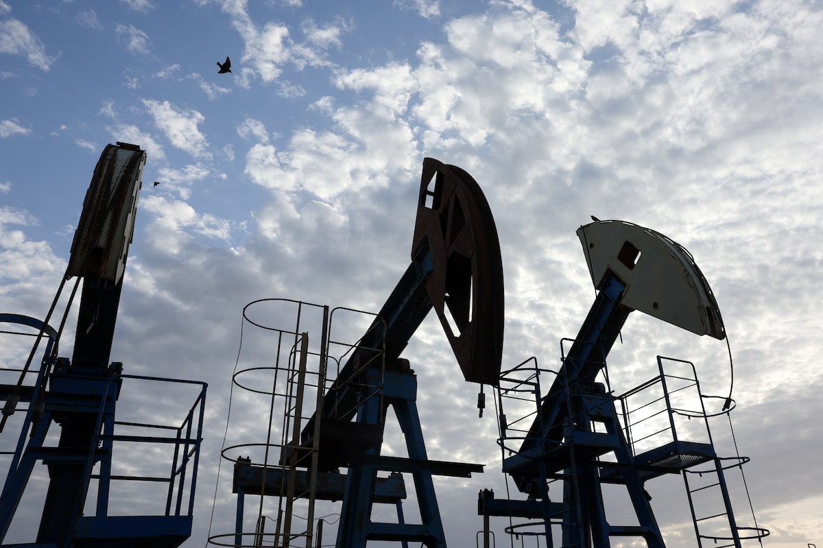 Three oil pumpjacks silhouetted against a cloudy sky at the Airankol field in western Kazakhstan, used as the ThriveInMarkets morning analysis hero for Tuesday August 18 2026, when West Texas Intermediate held near 85.30 dollars for a third session higher after the interim US-Iran memorandum expired Monday and overnight E-mini S&P 500 futures slipped toward 7,732 from Monday's 7,745.06 cash close