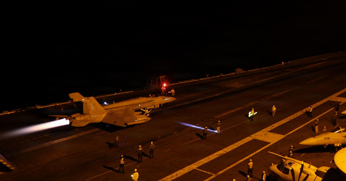 A US Navy fighter jet launches at night from a carrier deck, used as the ThriveInMarkets morning analysis hero for Monday August 31 2026, when West Texas Intermediate jumped about 3 percent toward 85.70 dollars after US forces struck two Iranian rocket launchers on Larak Island that Central Command said were preparing to fire sea mines into the Strait of Hormuz, the first publicly acknowledged American strikes on Iran since late July