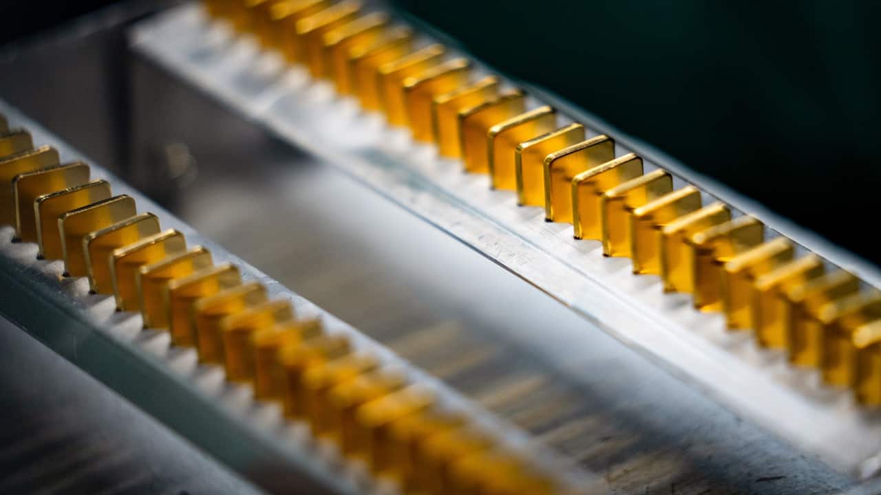 Rows of small gold bars sit in a production tray under factory lighting, used as the ThriveInMarkets morning analysis inline image for Monday September 7 2026, when spot gold slipped through 4,400 dollars to near 4,399 as CME FedWatch held about a 58 percent chance of a September rate hike after Friday's 162,000 payrolls print