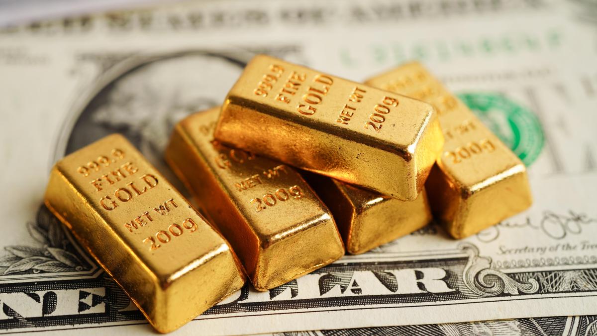 Small 200 gram gold bars stamped 999.9 Fine Gold sit on a US dollar bill, used as the ThriveInMarkets morning analysis inline image for Tuesday September 8 2026, when spot gold held near 4,408 dollars after an Asian Reuters print near 4,433 faded, with CME FedWatch still assigning about 58 to 60 percent odds of a September rate hike ahead of Friday CPI