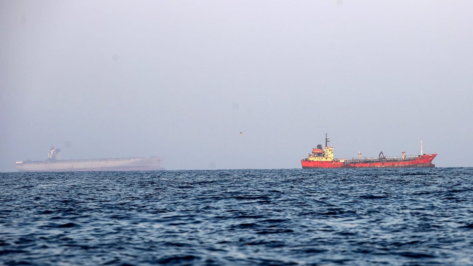A red-hulled tanker and a gray bulk carrier on open water, used as the ThriveInMarkets morning analysis hero for Thursday October 8 2026, when West Texas Intermediate last printed about 90.80 dollars after Wednesday's 88.28 settle, Brent sat near 102 dollars, Hormuz tanker attacks rose, and overnight E-mini S&P 500 futures sat near 7,826 against Wednesday's 7,801.77 cash close