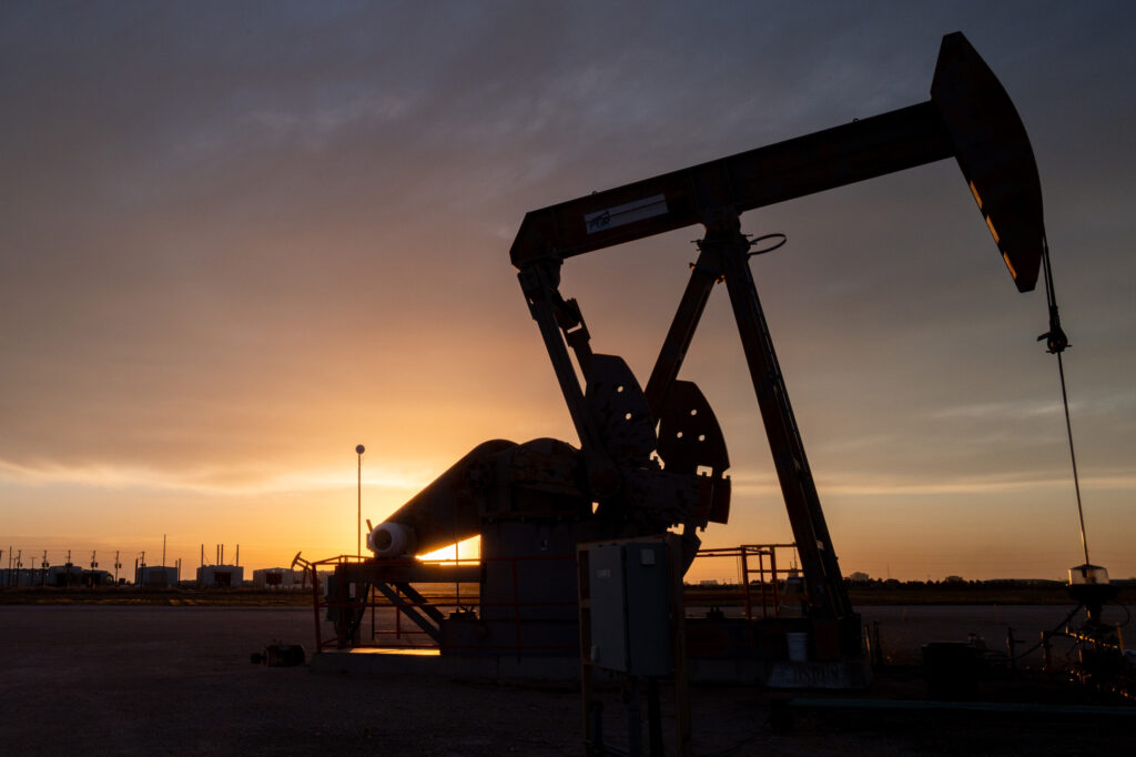 A pumpjack silhouetted against a Texas sunset with storage tanks on the horizon, used as the ThriveInMarkets morning analysis inline image for Wednesday October 14 2026, when West Texas Intermediate last printed about 94.54 dollars as Hormuz tanker attacks and a hit on an Aramco building in Dhahran kept a bid under crude
