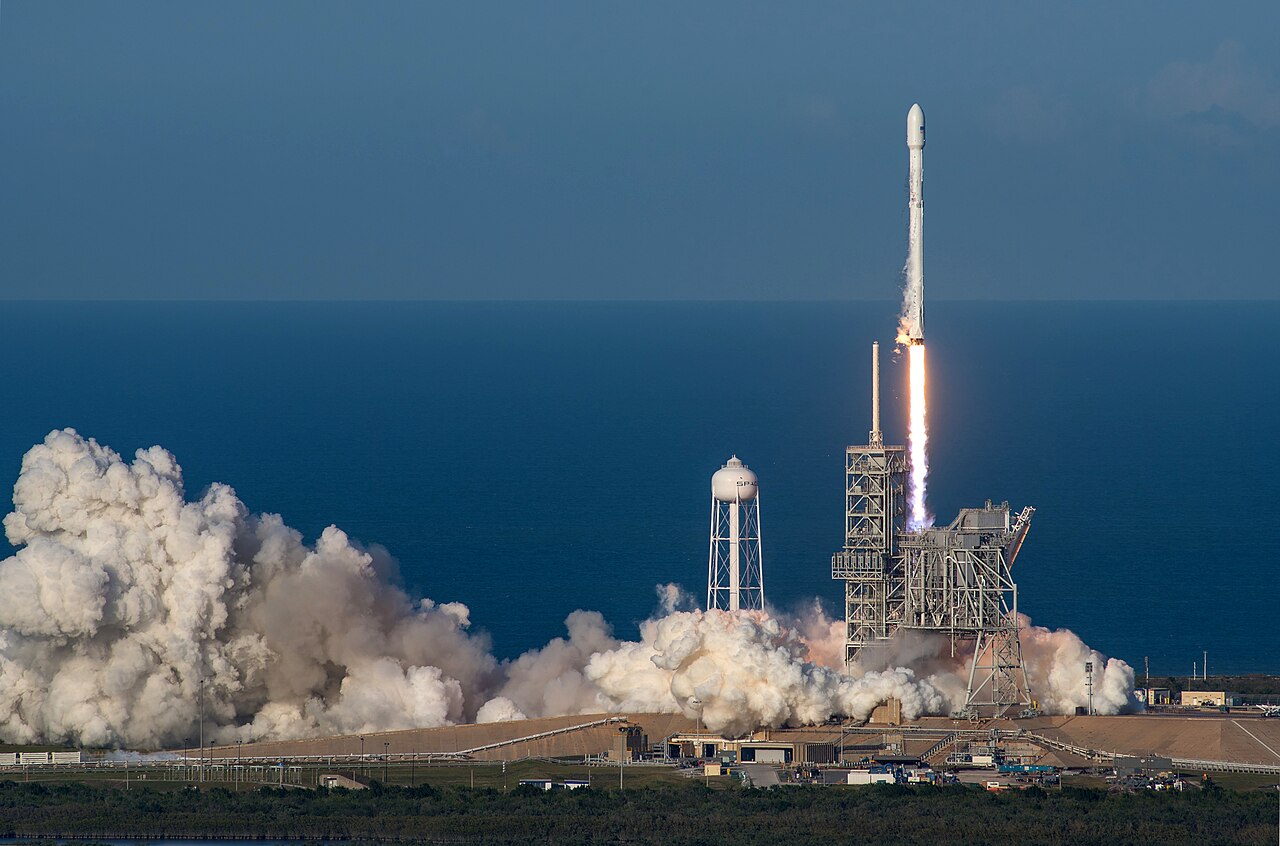 A SpaceX Falcon 9 rocket lifts off on a pillar of flame in the SES-10 mission, the world's first reflight of an orbital-class rocket, illustrating a June 10 2026 ThriveInMarkets explainer on the SpaceX initial public offering, the largest in history, which is expected to price on June 11 2026 and begin trading on the Nasdaq on June 12 2026 under the ticker SPCX at a target price of 135 dollars per share and a valuation of roughly 1.75 trillion dollars, with the company selling about 555.6 million shares to raise around 75 billion dollars while founder Elon Musk retains more than 82 percent of the voting control