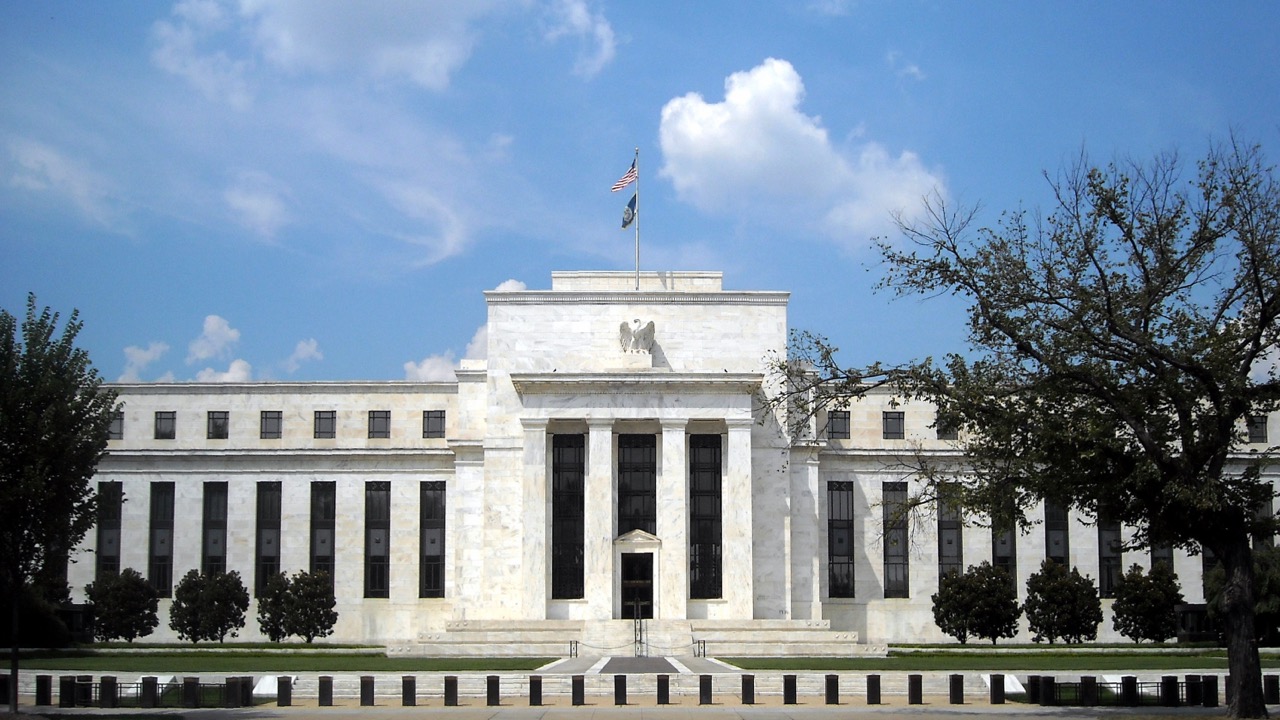 The Marriner S. Eccles Federal Reserve Board Building in Washington, a white marble facade with the American flag, used as the ThriveInMarkets inline image for the September 26 2026 article on the US debt funding twist and the Federal Reserve