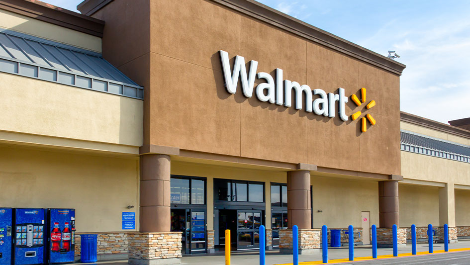 A Walmart Supercenter storefront with the chain's white and yellow logo on a tan facade, used as the ThriveInMarkets week-ahead hero for August 17 to 21 2026, a retail-earnings and FOMC-minutes week in which Home Depot reports Tuesday, Target and Lowe's report Wednesday, and Walmart reports Thursday after July retail sales fell 0.6 percent, with Wednesday's July 28-29 FOMC minutes set to unpack the first three-way hawkish dissent since 2016