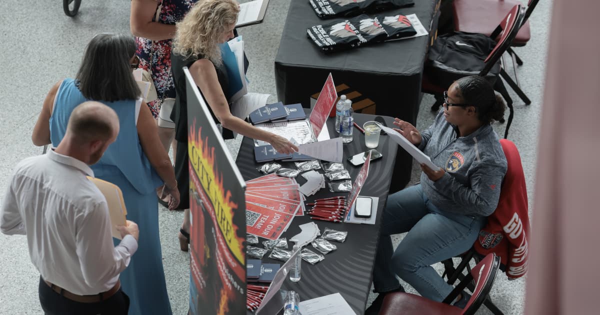 Job seekers meet recruiters at a hiring fair during the week of May 31 to June 6 2026, the week a far hotter than expected US May jobs report showing 172,000 nonfarm payrolls added against an 80,000 consensus and an unemployment rate steady at 4.3 percent revived bets on a Federal Reserve interest rate hike, sent the Nasdaq Composite plunging 4.18 percent on Friday June 5 in its worst session since April 2025 as a semiconductor slide led by Broadcom, Marvell, Micron, Nvidia and AMD wiped roughly 1 trillion dollars from US markets, snapped the S&P 500's run of weekly gains, and capped a brutal week for crypto in which bitcoin crashed from its 74,533 dollar record toward 64,000 dollars and US spot bitcoin and ether exchange-traded funds finally ended a record 13-day, 4.3 billion dollar outflow streak