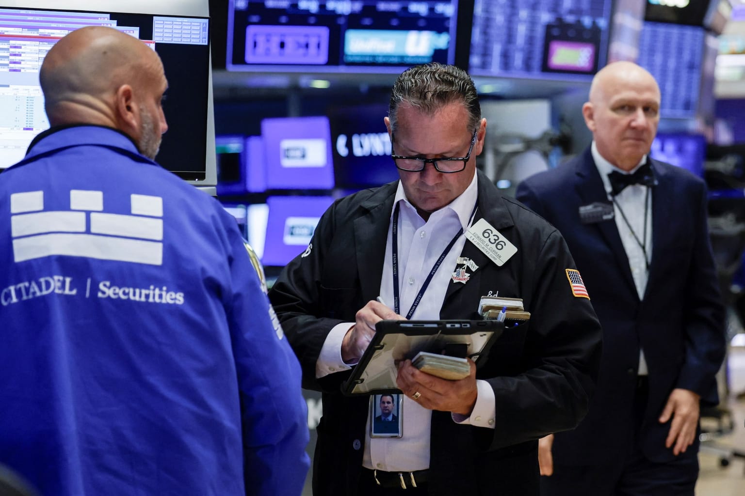 NYSE floor traders, including a Citadel Securities specialist in a blue jacket, work the tape on Wednesday August 19 2026, the session Treasury said it would at least double long-end liquidity-support buybacks and Moderna closed about 177 percent higher, the hinge of a week in which the S&P 500 snapped a three-week winning streak, Walmart comps missed, and Bitcoin surged toward 80,000 dollars